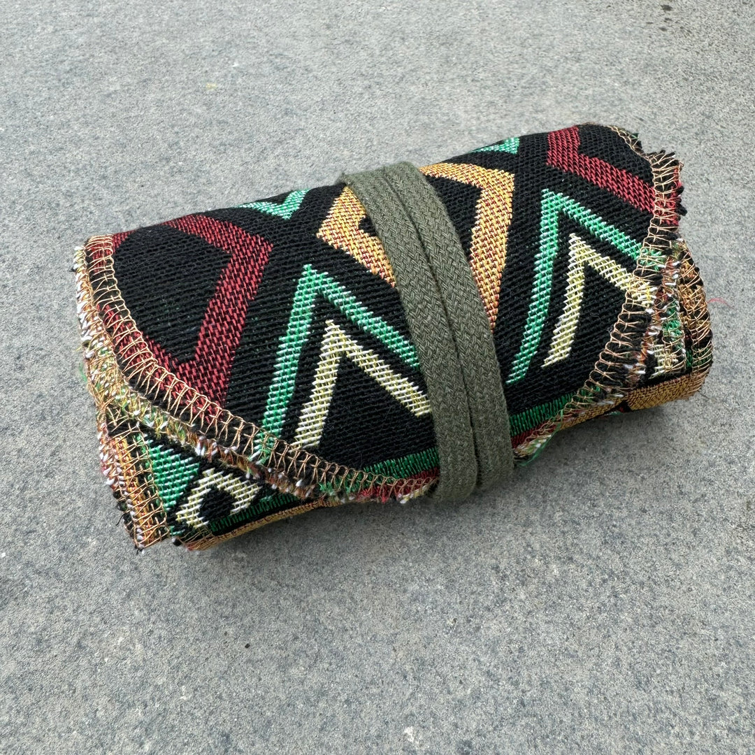 Green Aztec cotton leg wraps, folded, for medieval LARP attire.