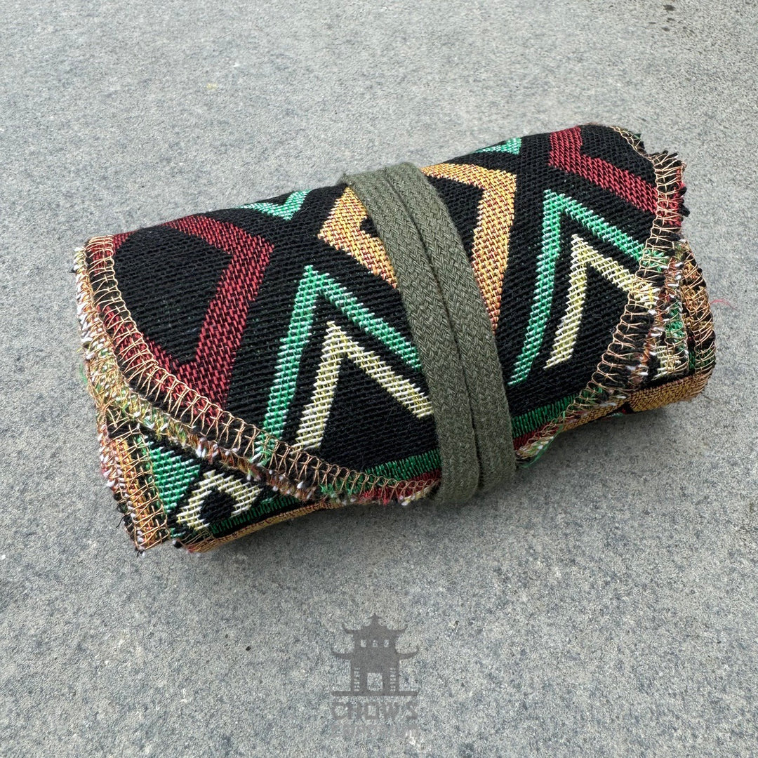 Folded green Aztec pattern pirate sash for LARP, textile fabric, side view.