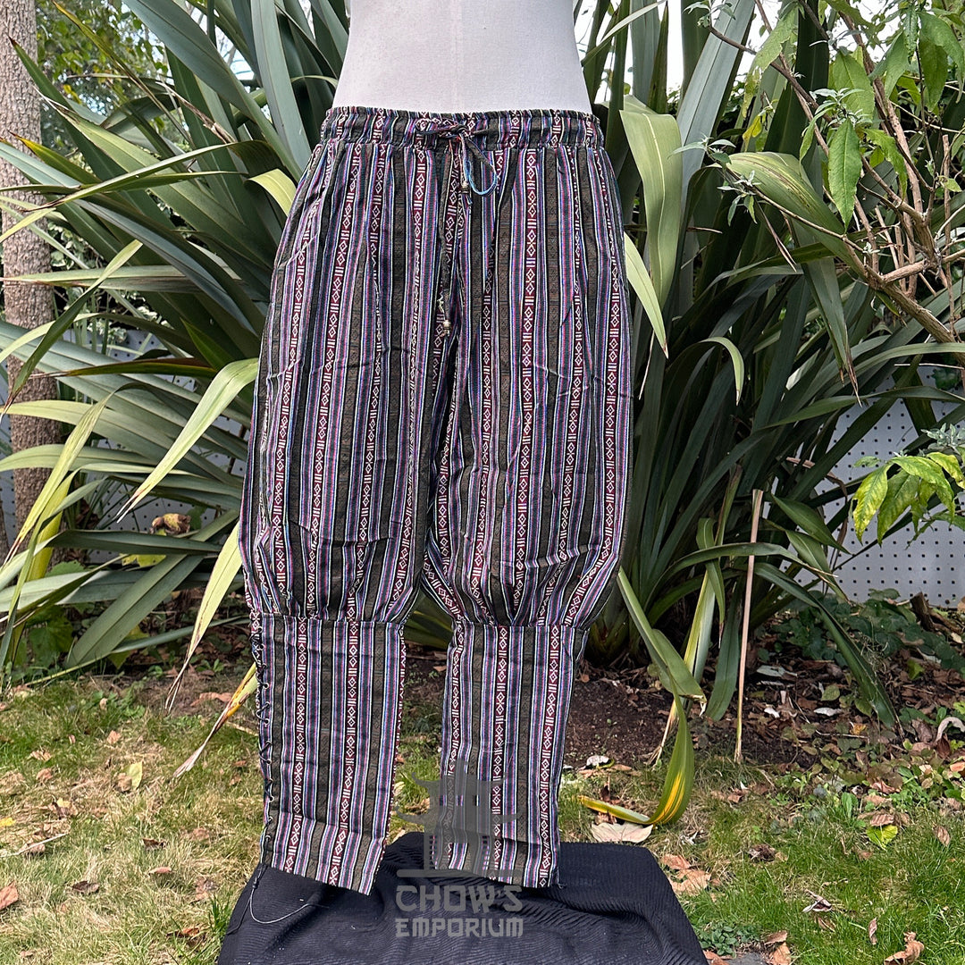 Front view of green multi cotton Viking pants with elasticated waist and ankles for LARP or.