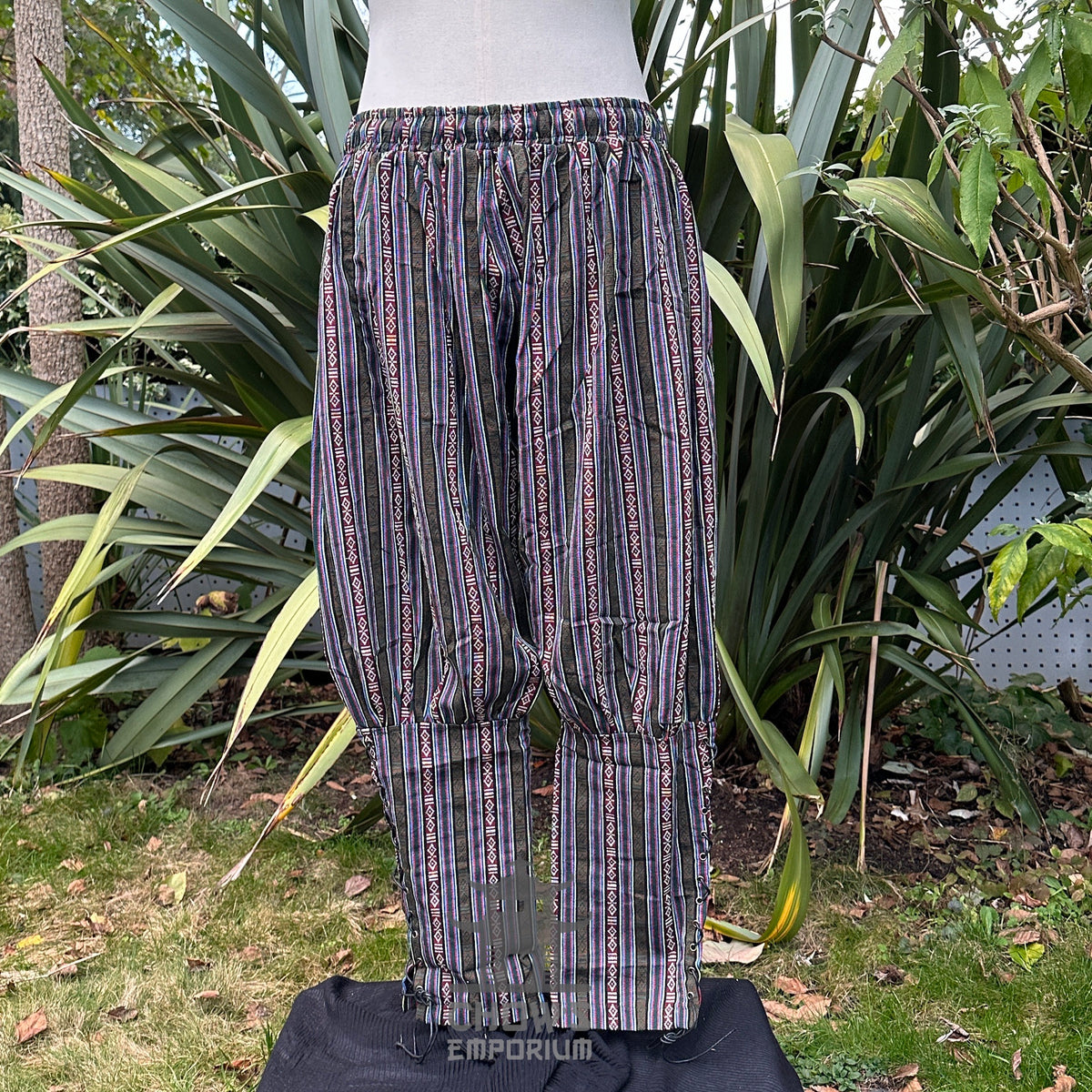 Front view of striped LARP medieval pants with colourful geometric patterns.