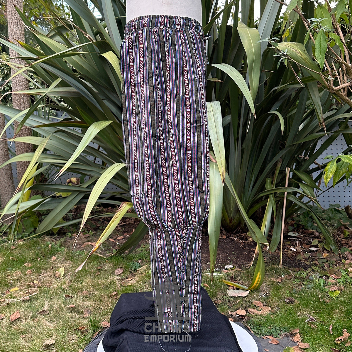 Side view of green cotton Viking-style pants with cord tie and ankle gathers no boots.