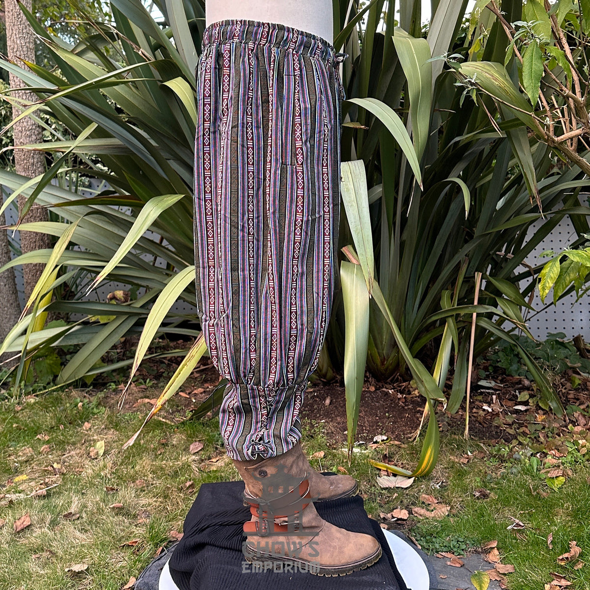 Side view of green cotton Viking-style pants with cord tie and ankle gathers.