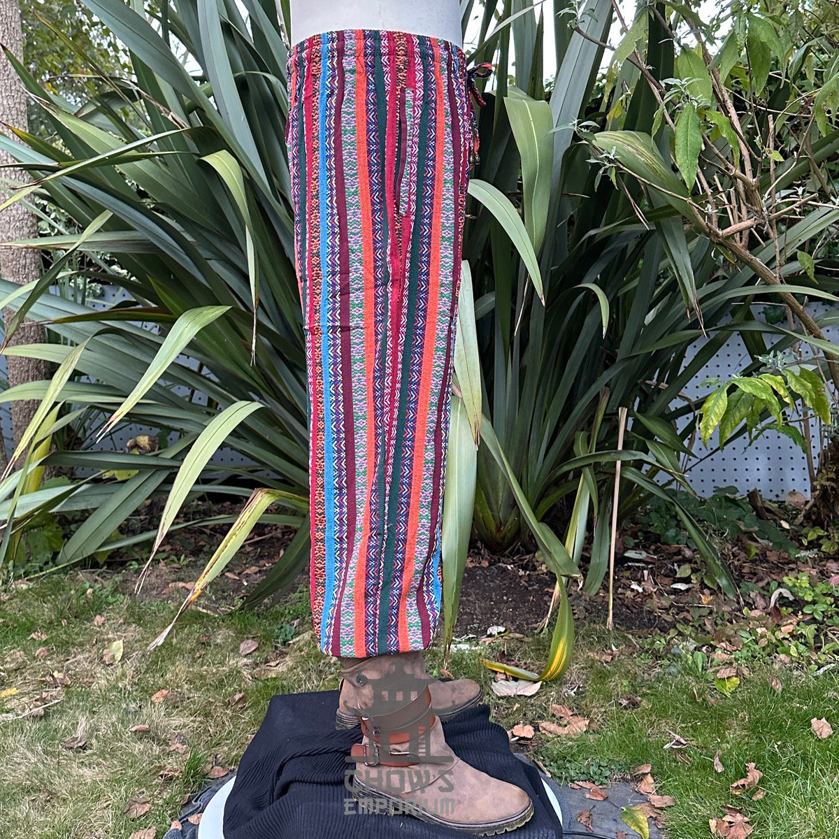 Side view of striped medieval LARP pants with lush greenery.