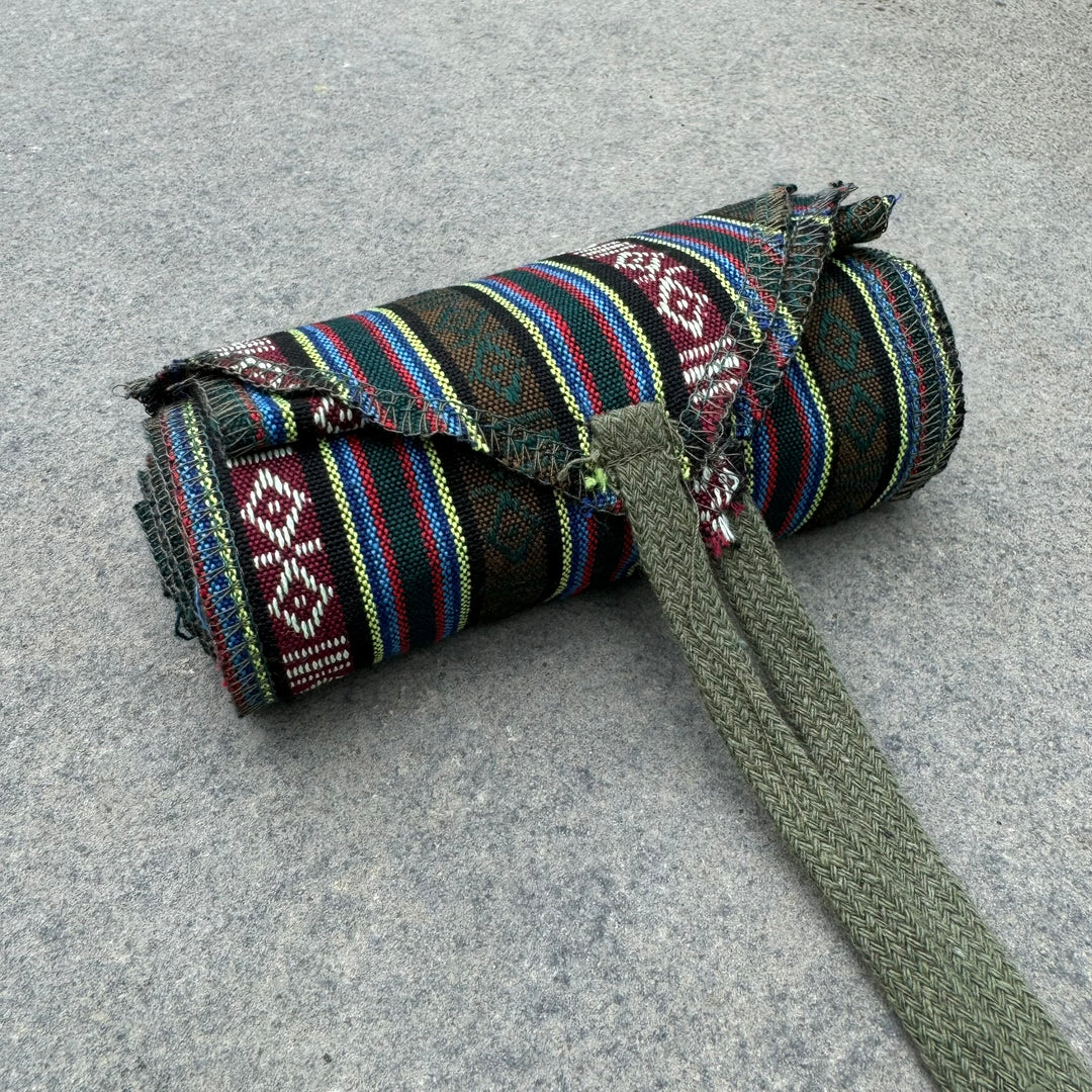 Medieval LARP green striped leg wraps in rolled display.