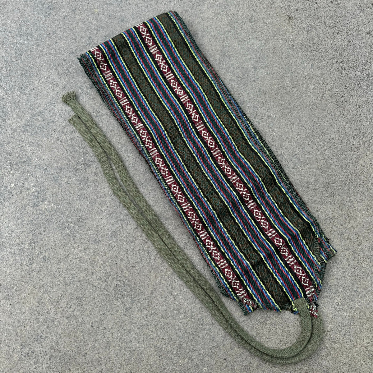 Green striped medieval LARP leg wraps with multicolor patterns, top view.