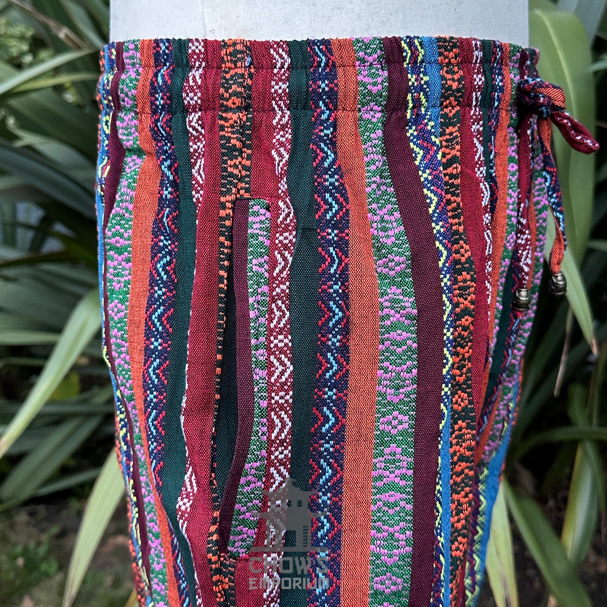 Detail of striped cotton-linen fabric texture and reinforced seam construction.