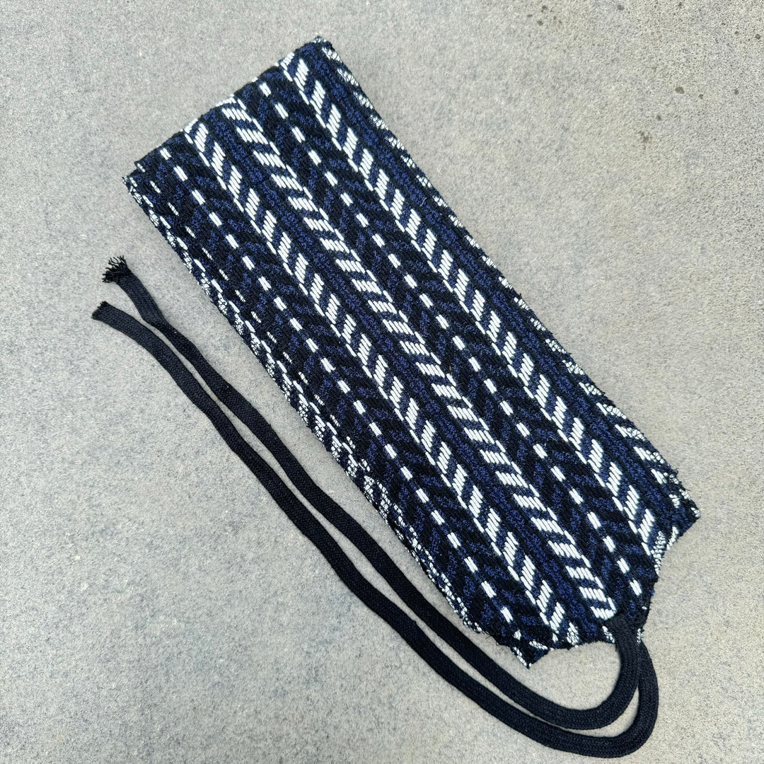 LARP sash, angled view, blue, black, white herringbone knitted wool.