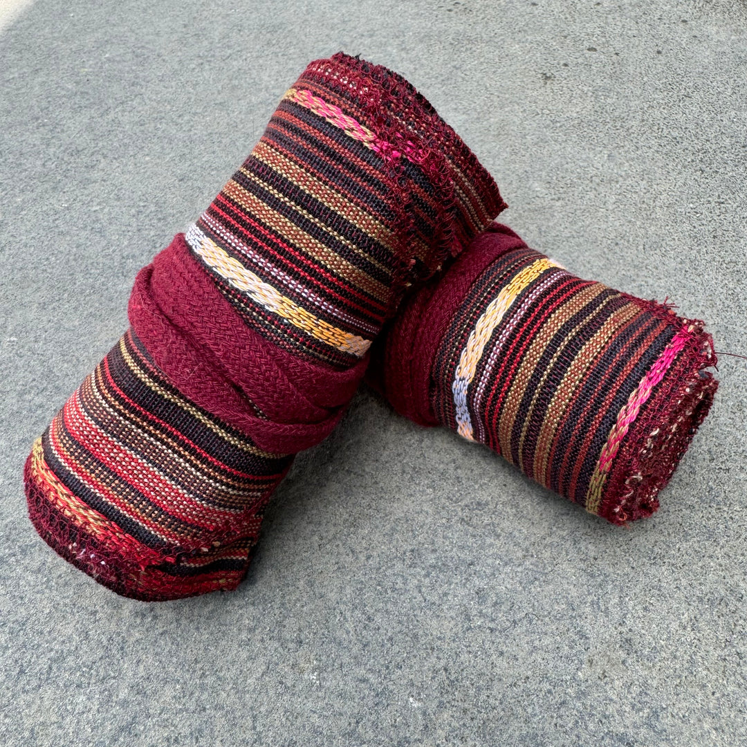 Red striped cotton leg wraps for LARP or medieval costume, side view.