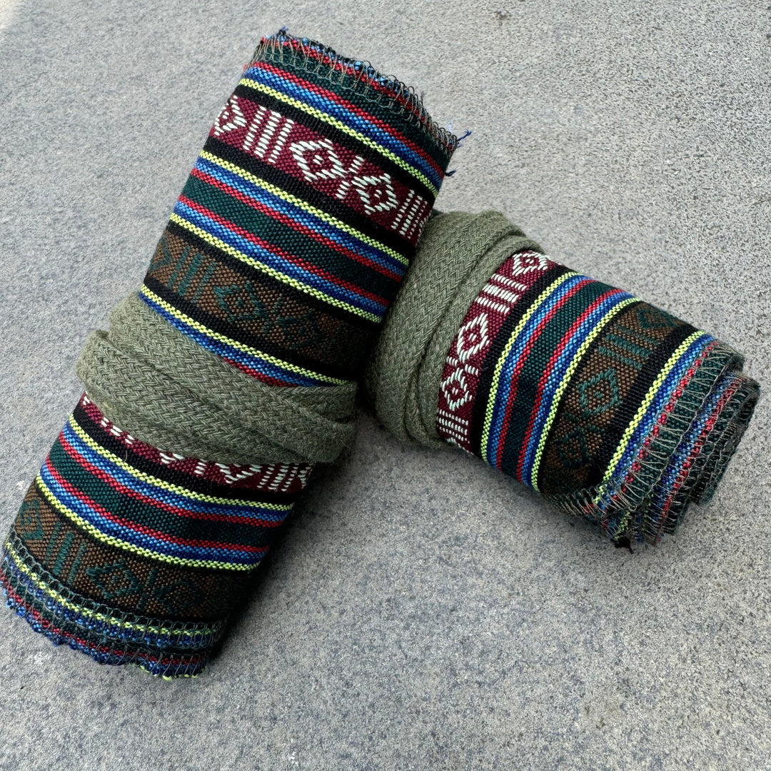 Green and striped LARP medieval leg wraps with woven patterns, side view.
