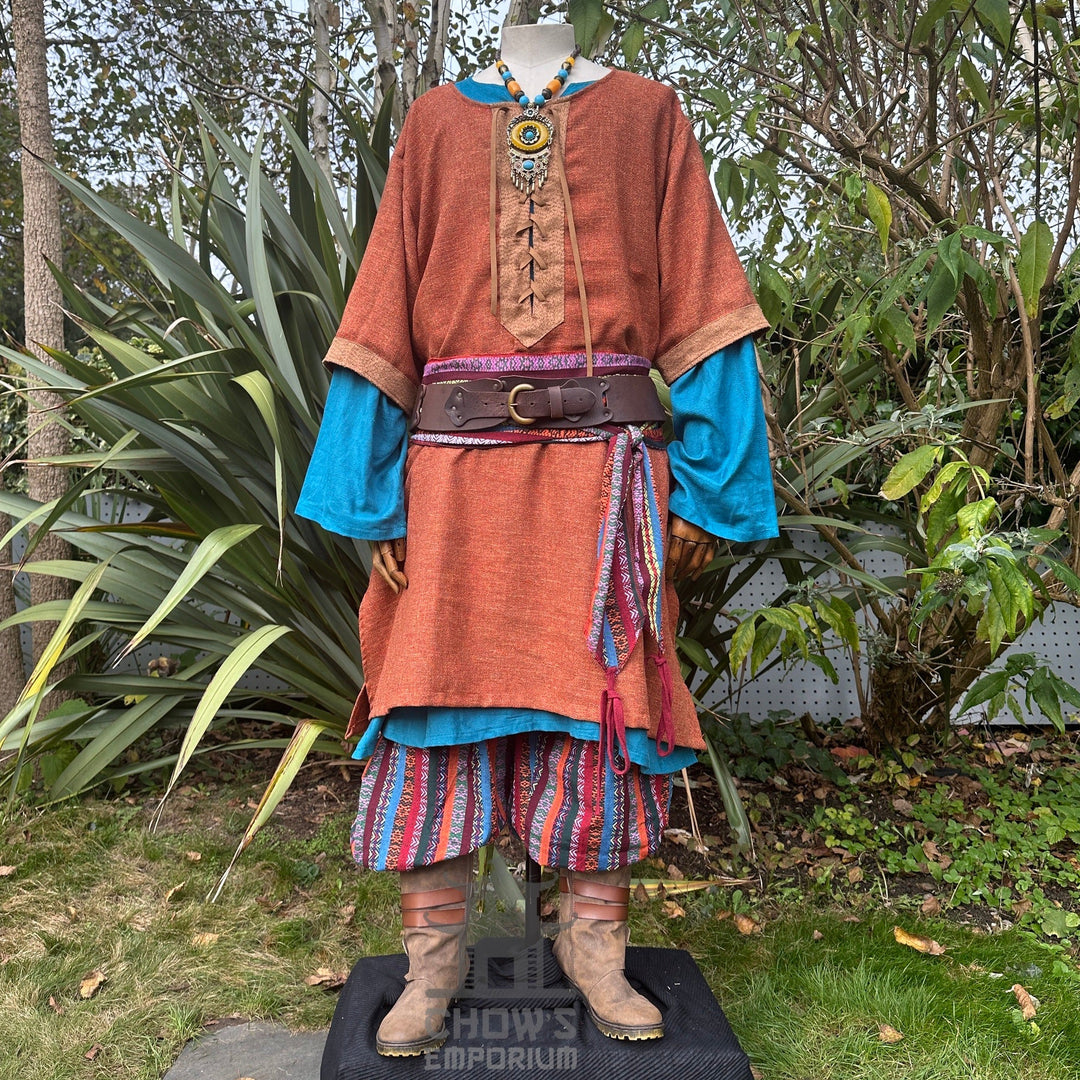 Autumn Druid LARP outfit with orange tunic, striped trousers.