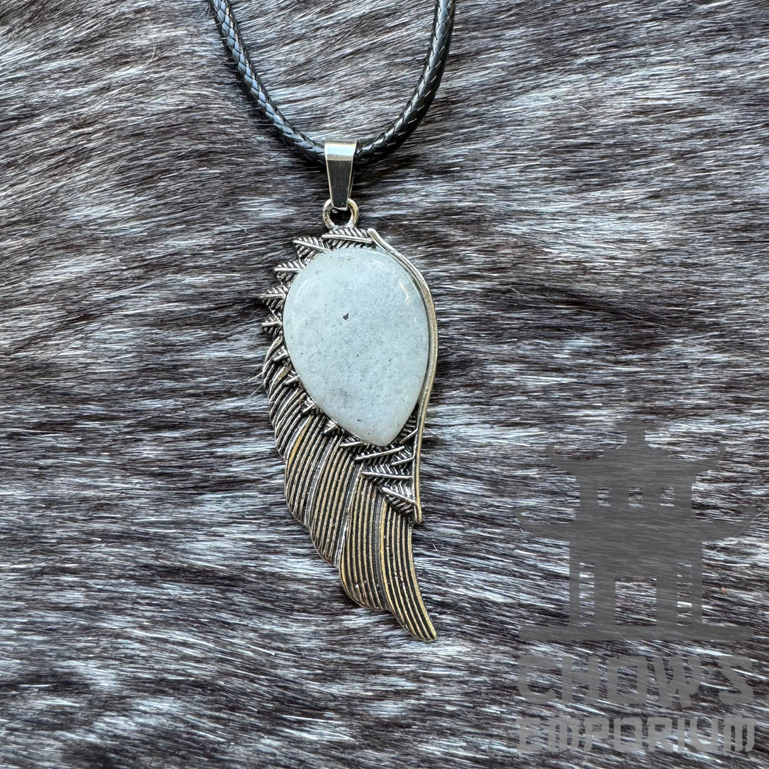 Silver feather necklace with stone pendant on textured fur background. LARP accessory.