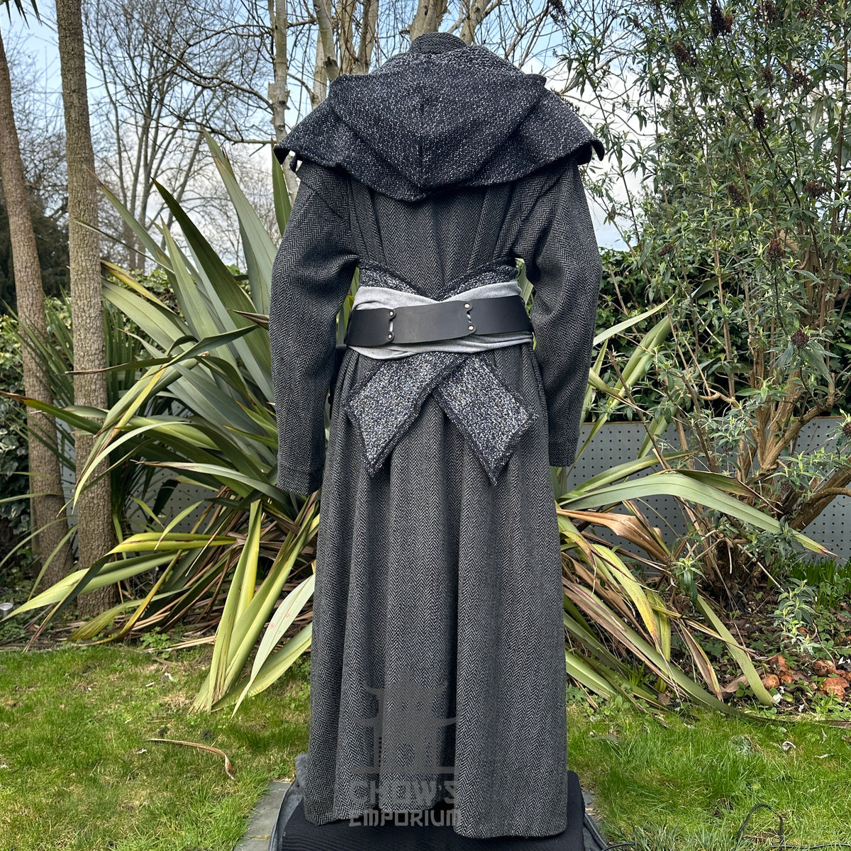 Back view of a medieval LARP outfit with grey herringbone robe, hood, and sash.