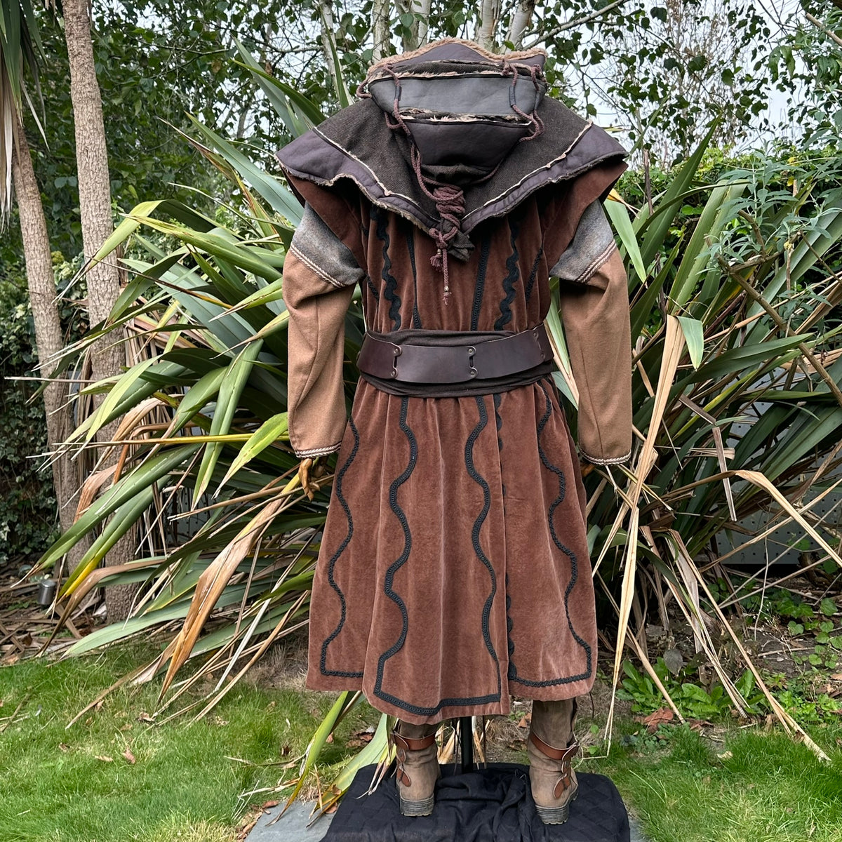 Back view of medieval LARP outfit with layered hood and brown waistcoat.