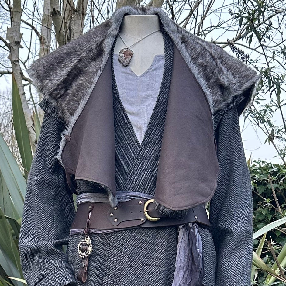 LARP grey fur mantle shoulder cape with dark fabric, front view.