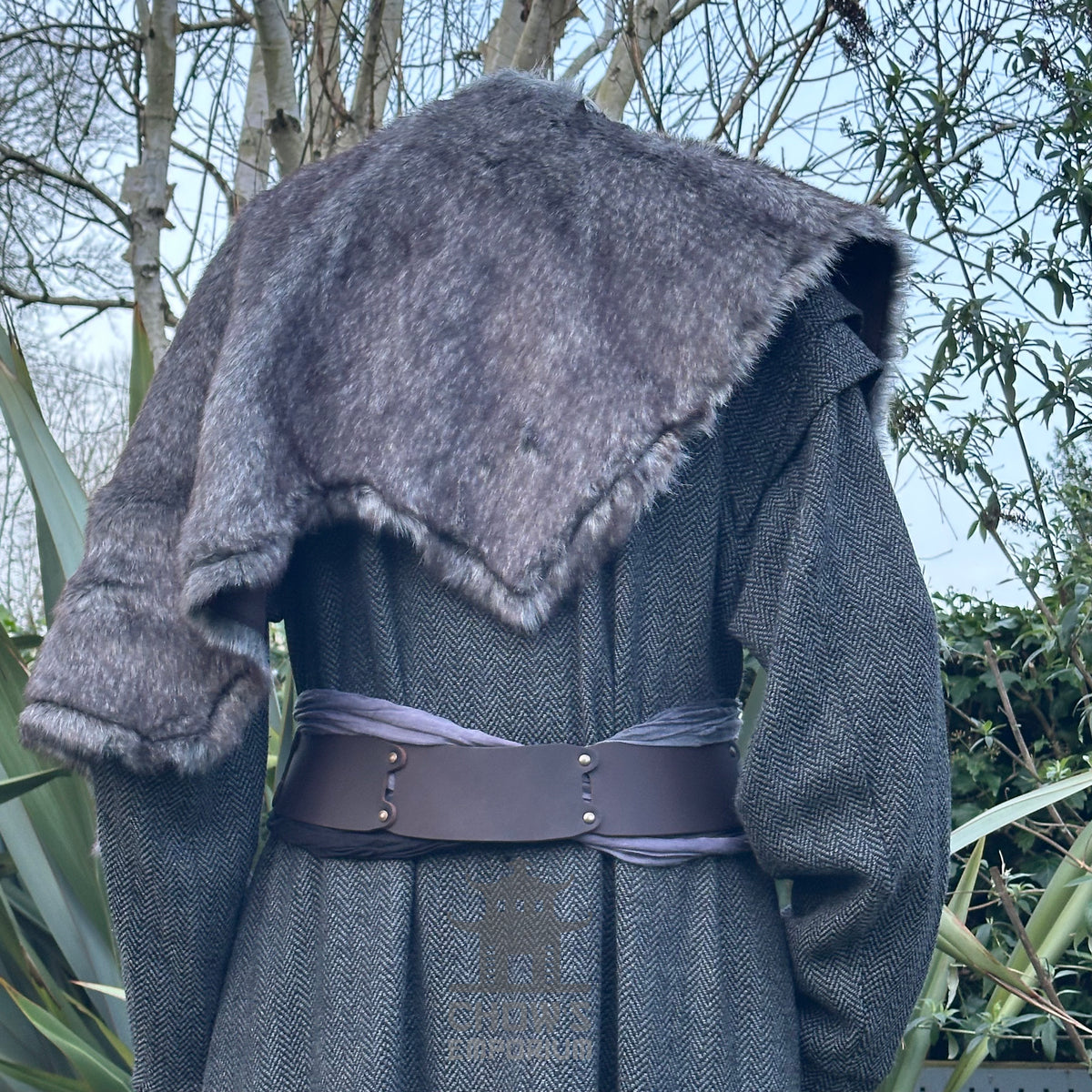 Grey fur mantle draped over medieval gown, viewed from the back.