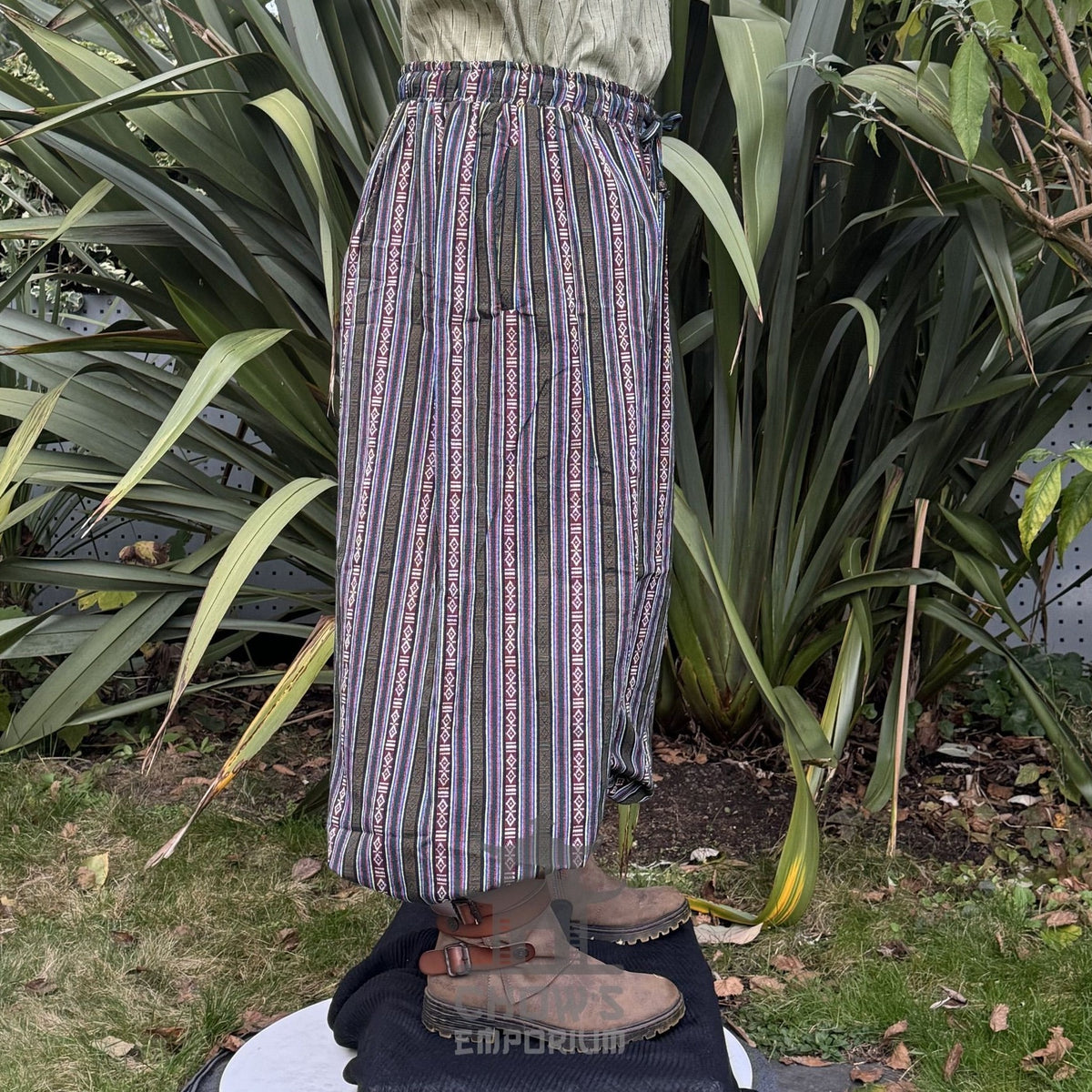 Medieval LARP striped pants with earthy tones, side view in forest setting.