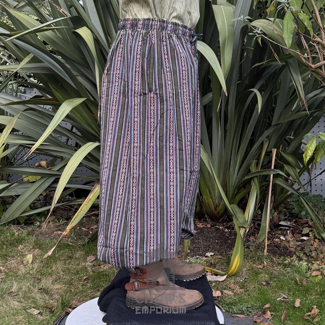 Medieval LARP striped pants with earthy tones, side view in forest setting.