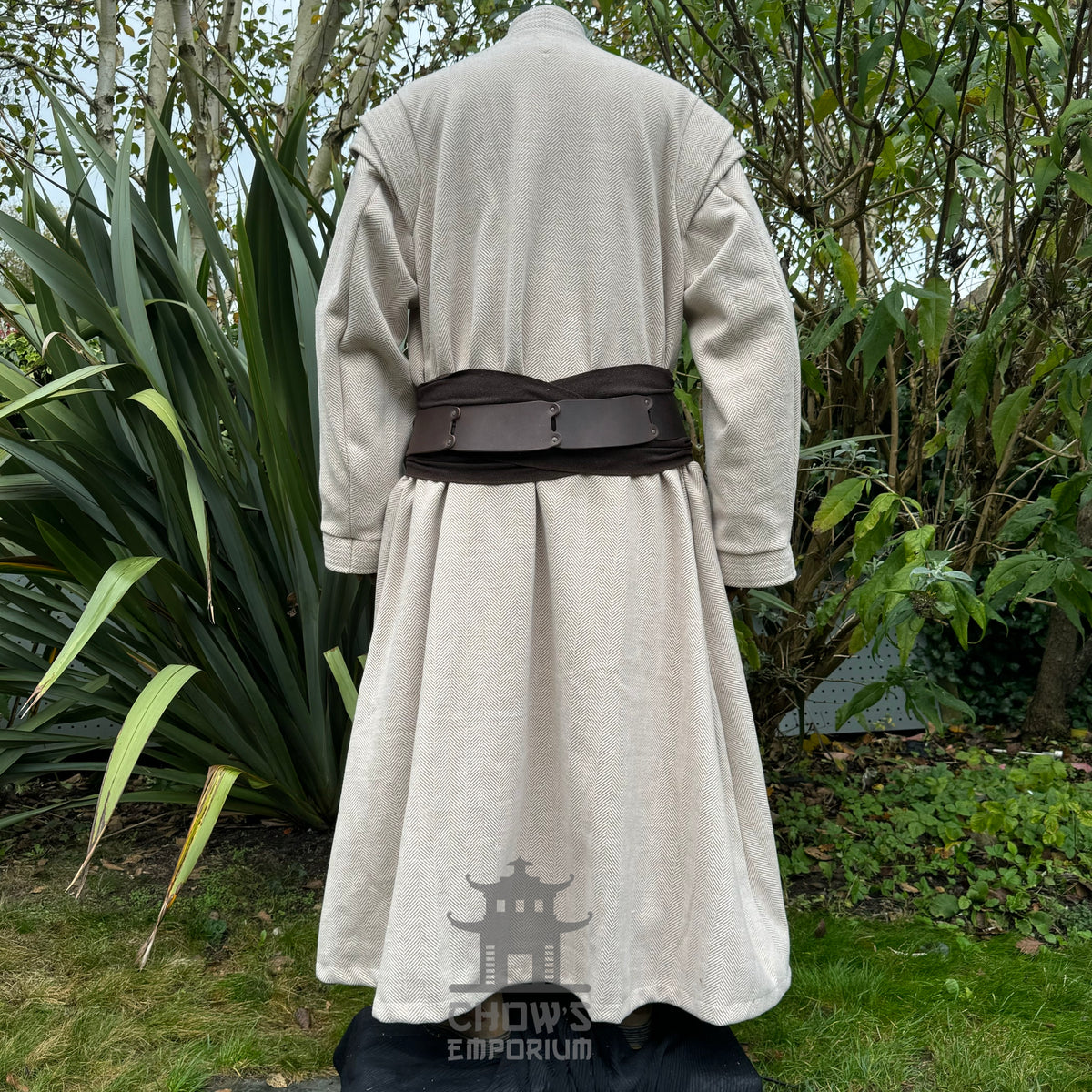 Back view of beige and brown medieval LARP robe with belt worn over the outer layer, fantasy.
