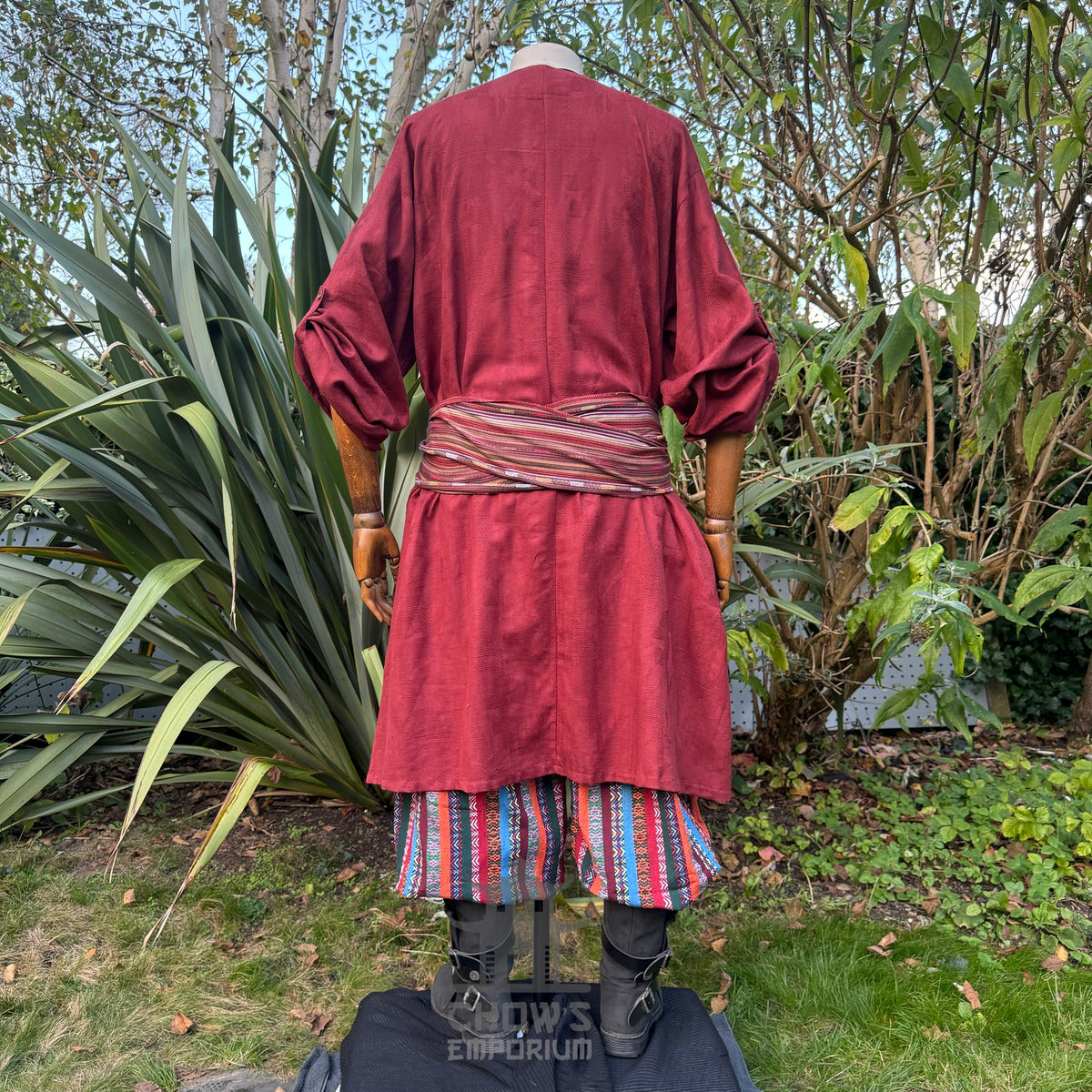 LARP medieval outfit: red tunic, striped pants and sash, rear view.