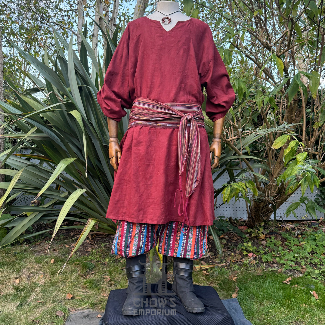 LARP medieval red tunic, striped pants, and sash on mannequin.