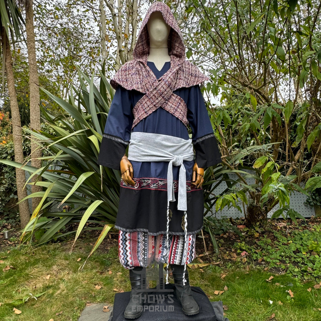 Medieval LARP outfit front view, featuring a blue and black tunic, patterned trousers, and sash.