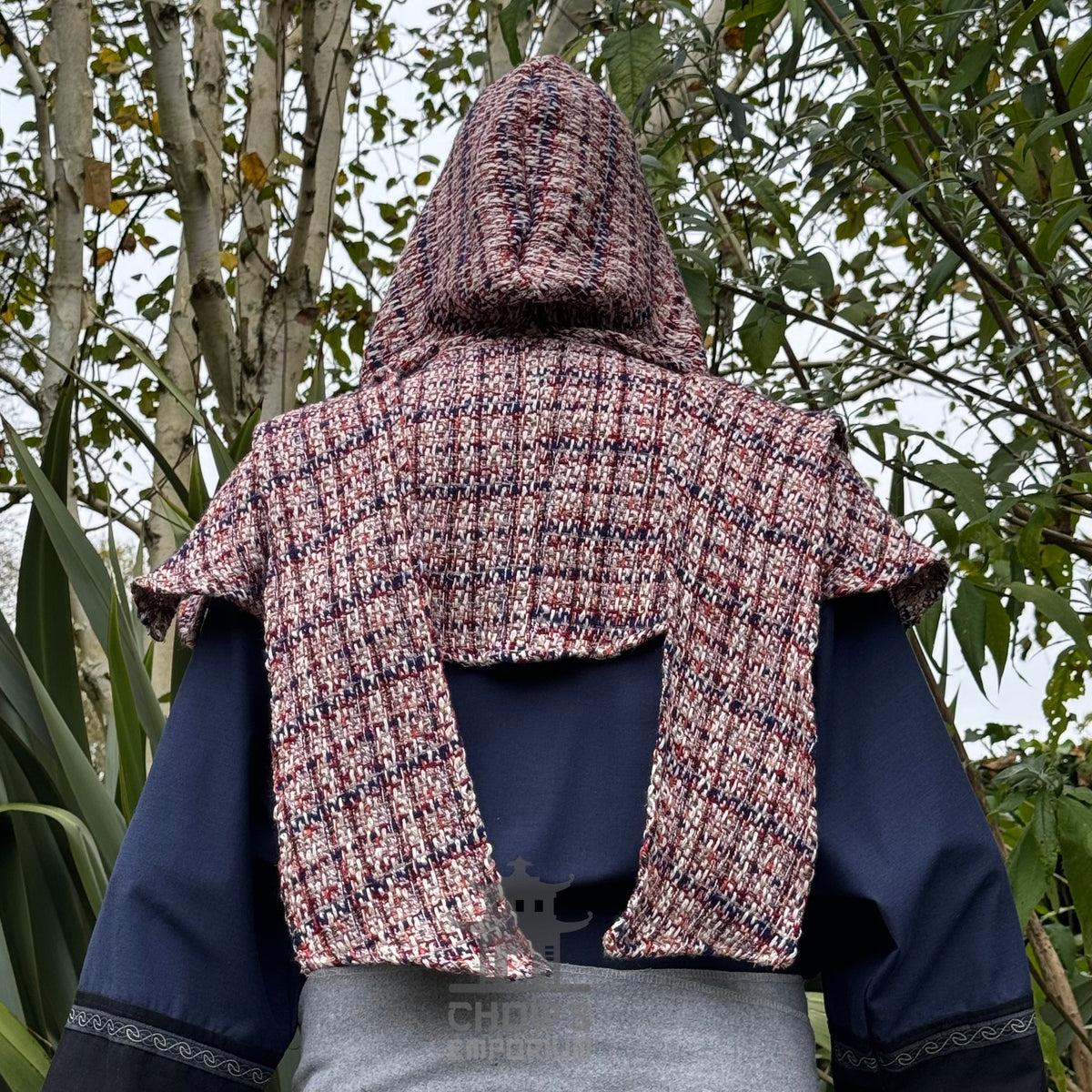 Back view of medieval LARP set, hooded, textured tunic with blue sleeves.