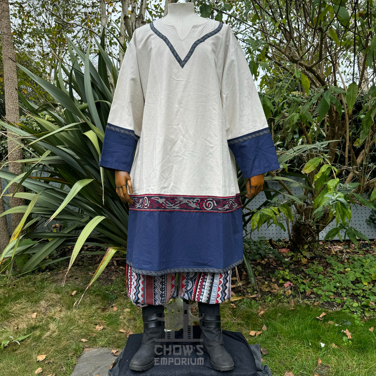 LARP medieval tunic in white and blue with patterned trim, displayed on mannequin.