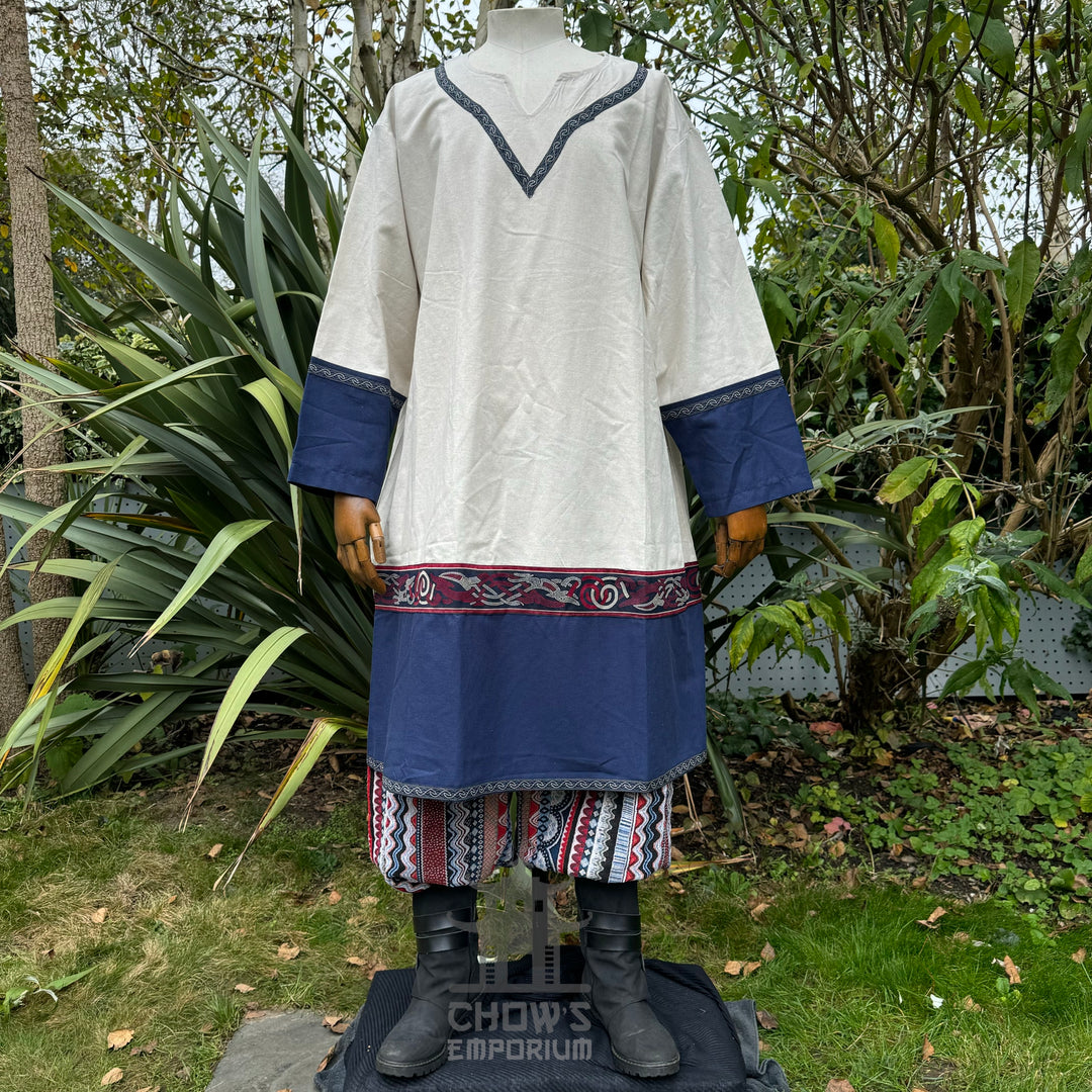 LARP medieval tunic in white and blue with patterned trim, displayed on mannequin.