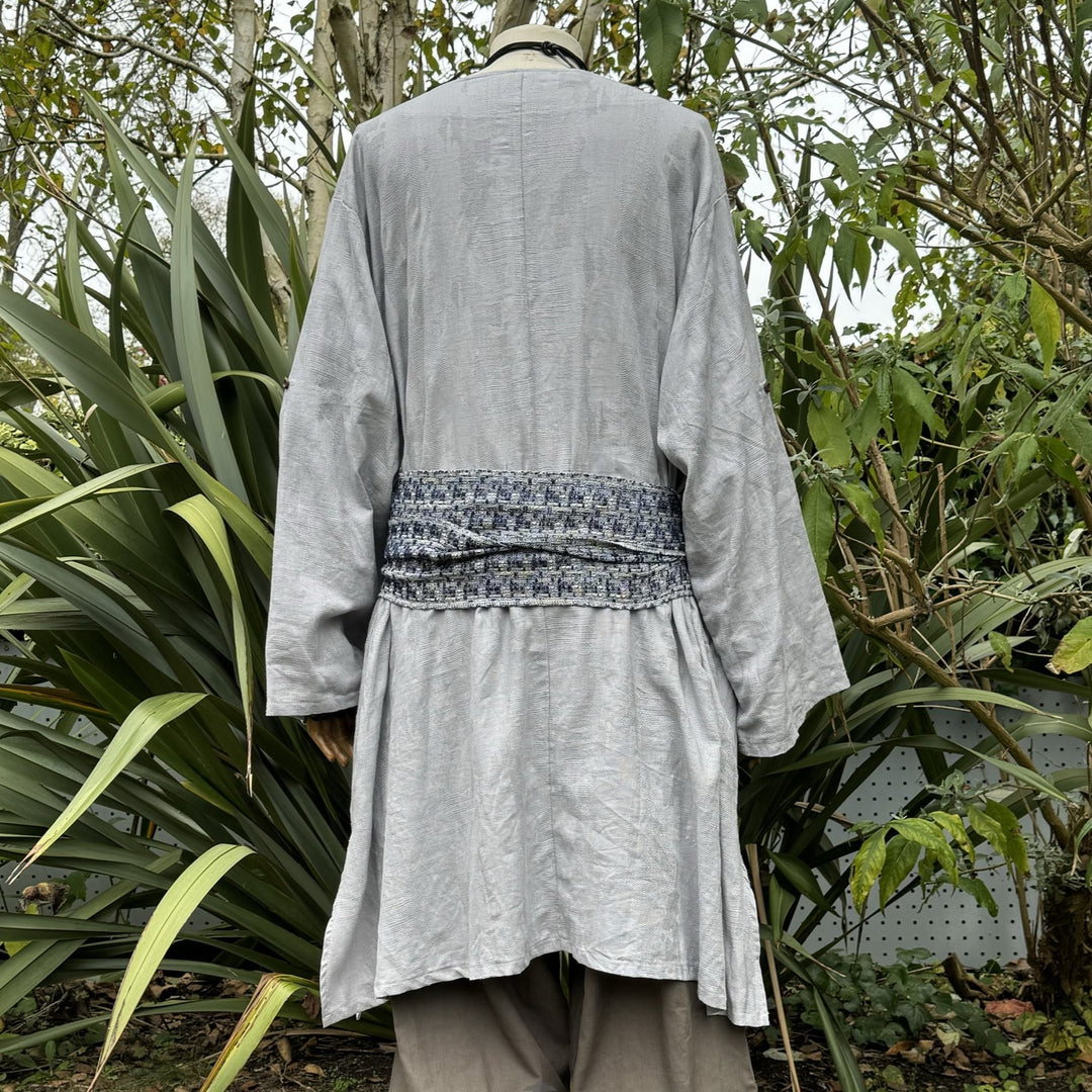 Back view of grey medieval LARP tunic with textured sash.