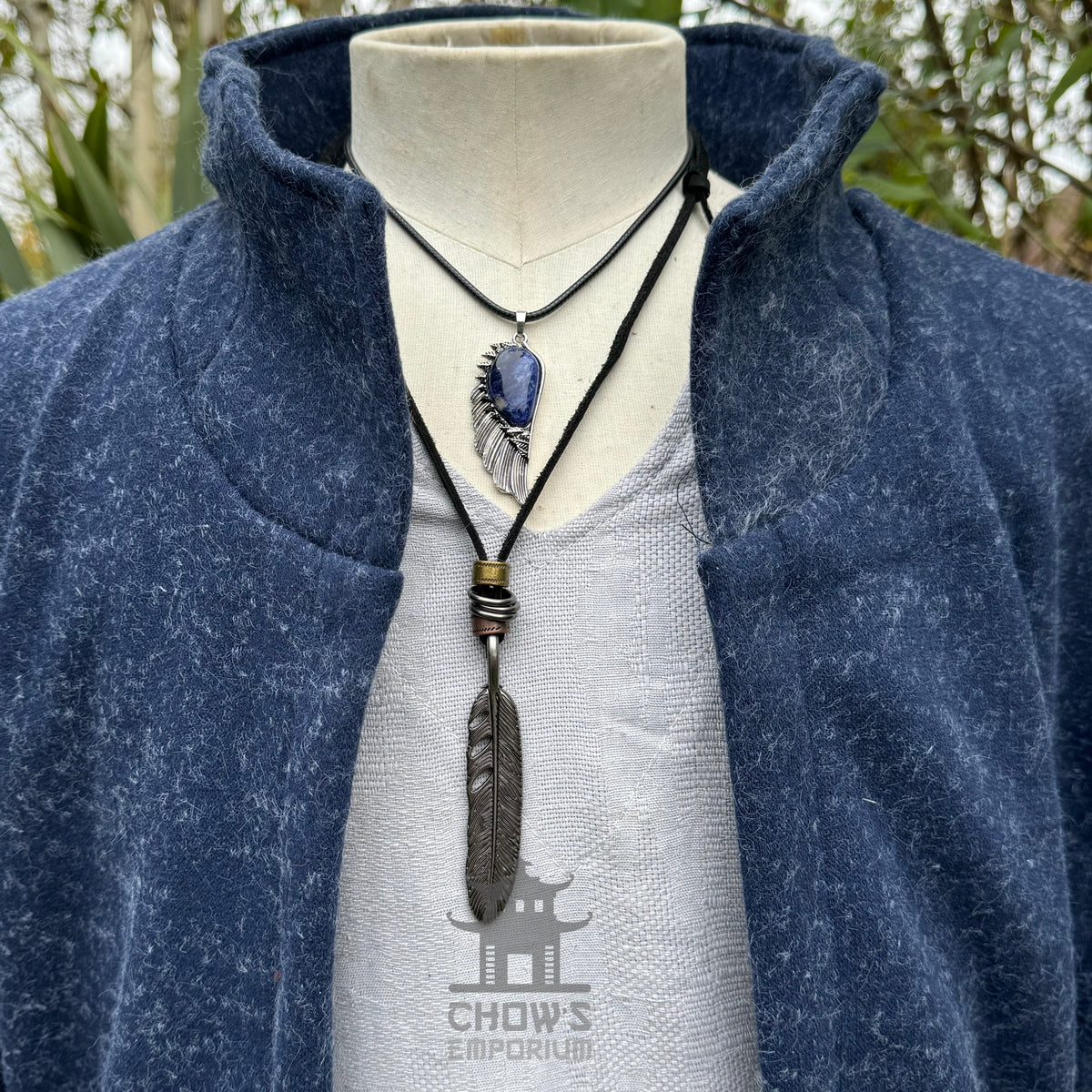 Mannequin with blue wool waistcoat, high collar, and necklaces for LARP.