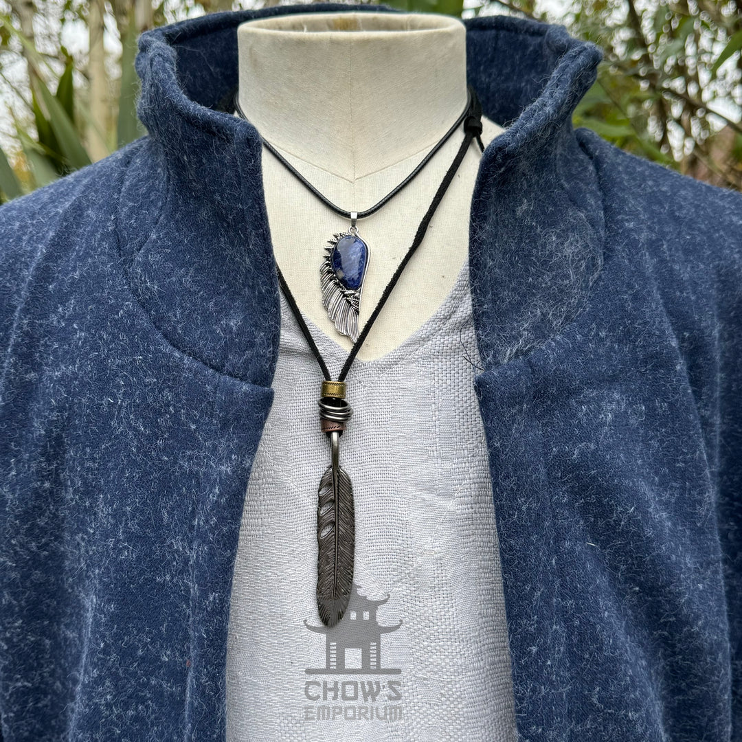 Mannequin with blue wool waistcoat, high collar, and necklaces for LARP.