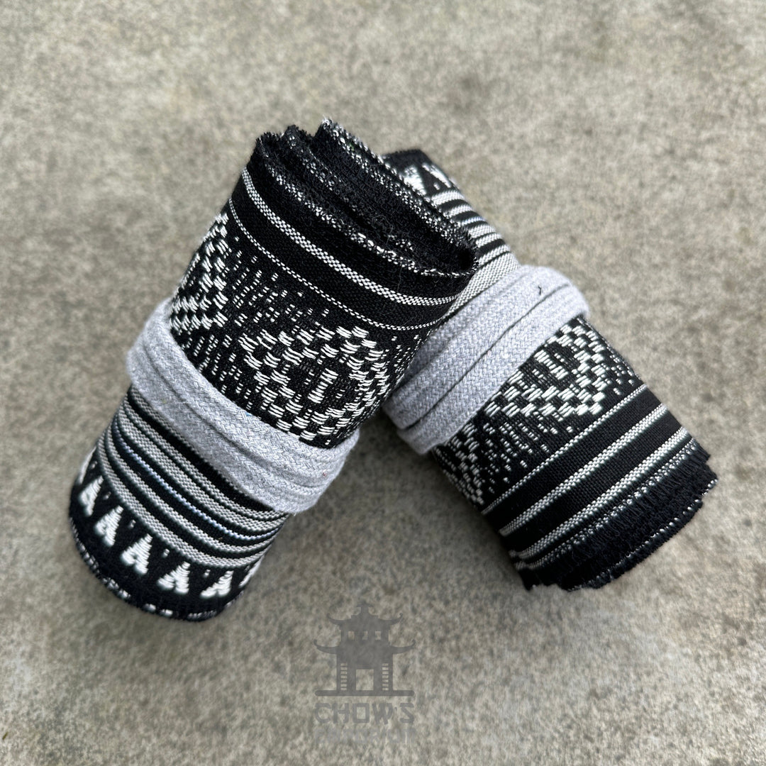 LARP black and white patterned cotton leg wraps, folded on concrete surface.