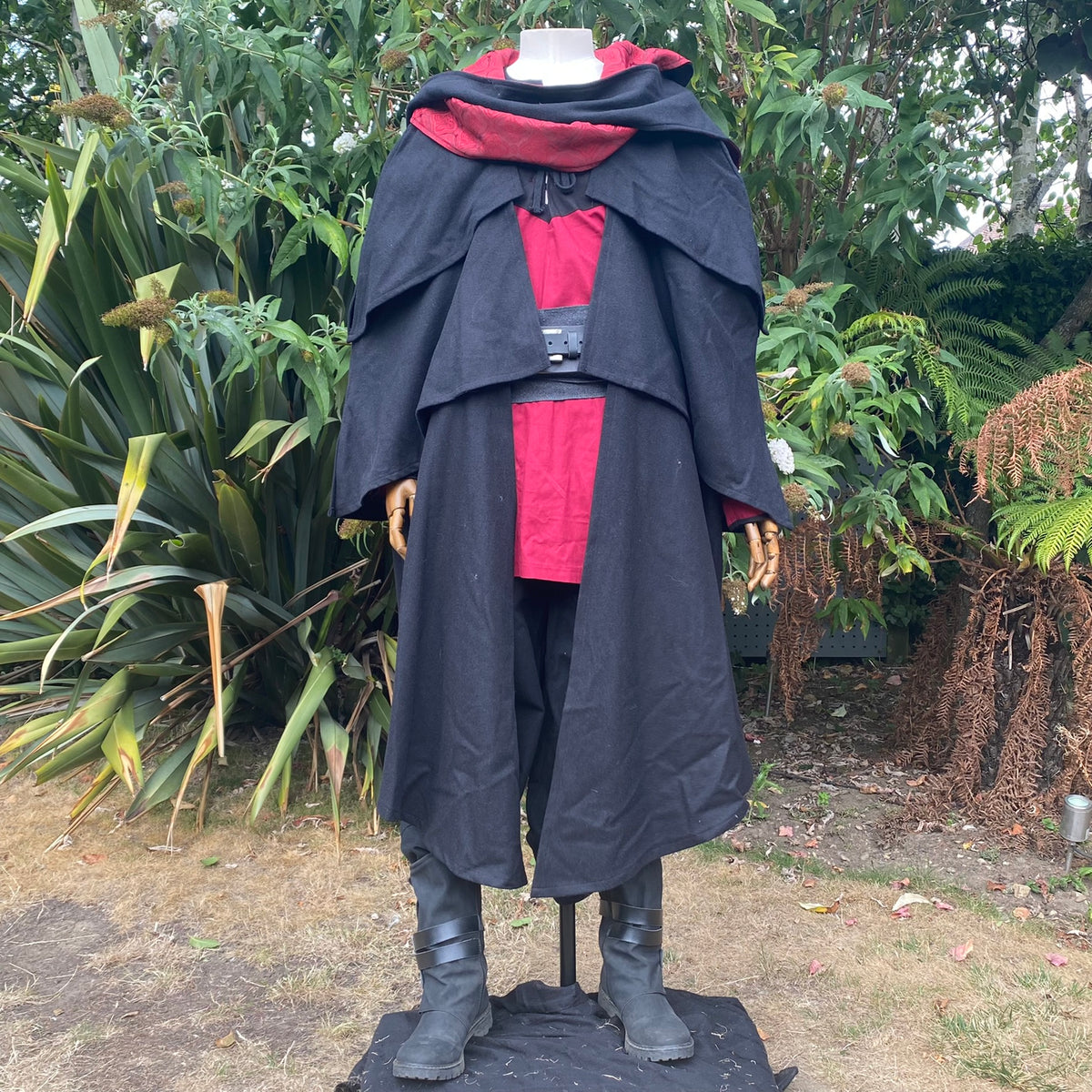 Black cloak and red shirt LARP set with belt on mannequin.