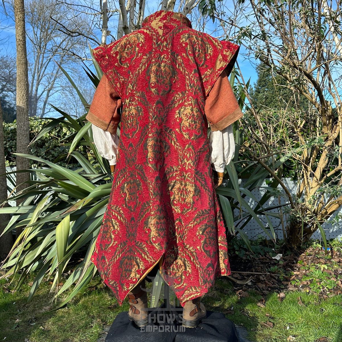 Rear view of crimson medieval tunic with gold motifs for LARP.