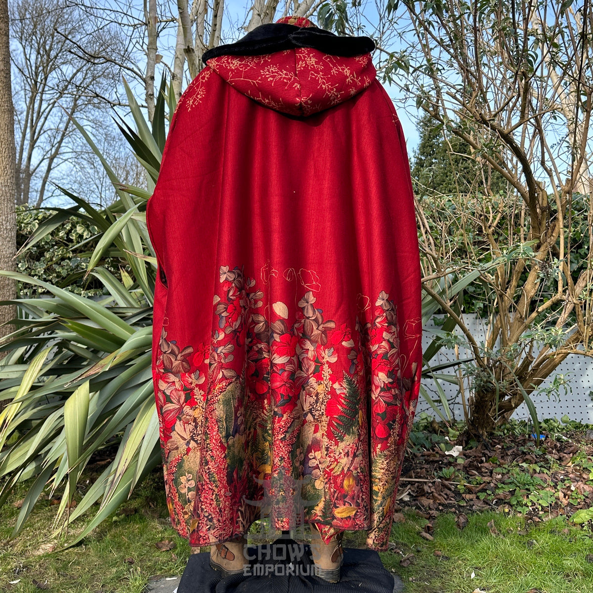 Rear view of LARP cloak, rich red fabric with floral details and fur-lined hood.