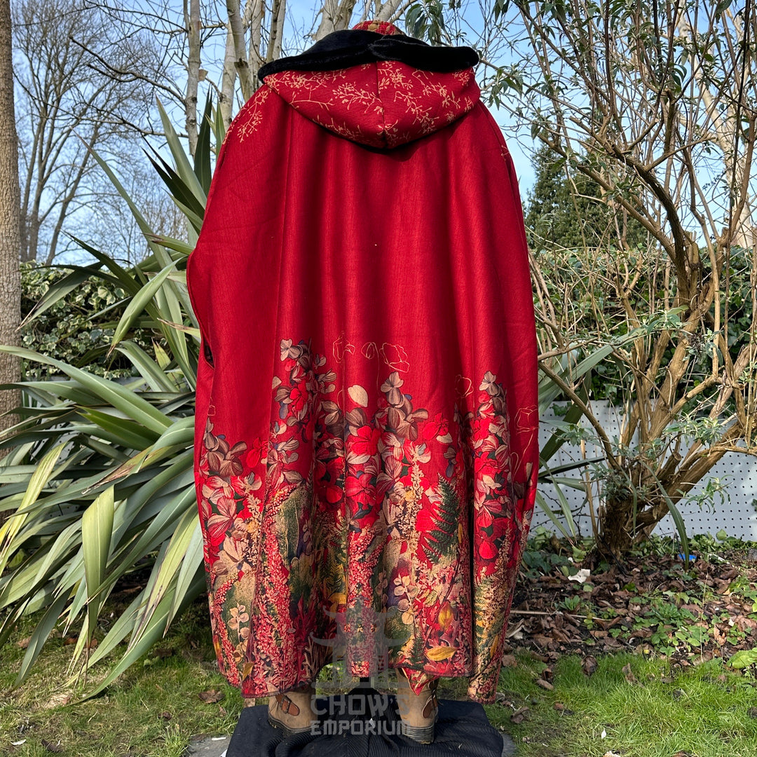 Rear view of LARP cloak, rich red fabric with floral details and fur-lined hood.