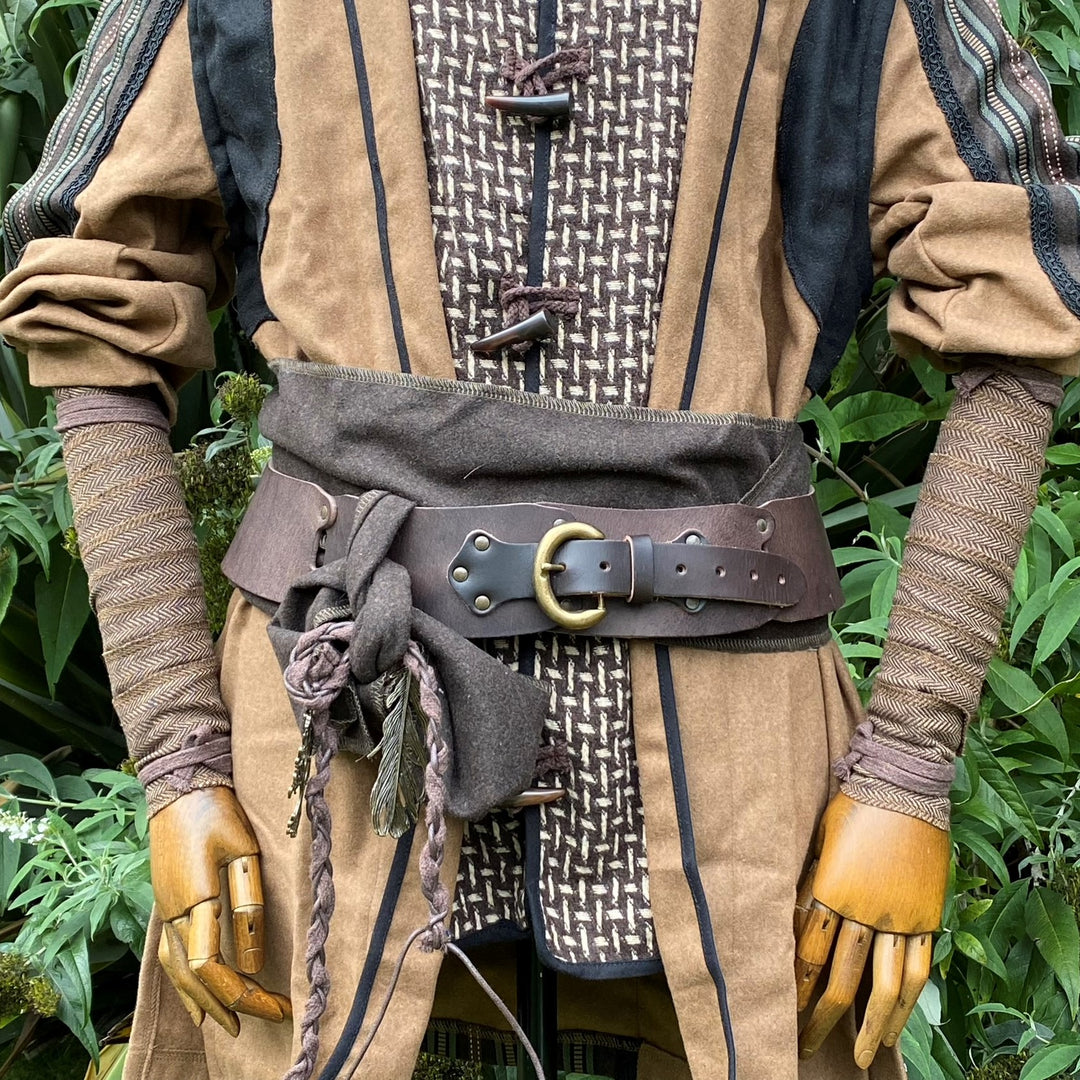 Close-up of medieval LARP outfit with patterned arm wraps and belt detail.