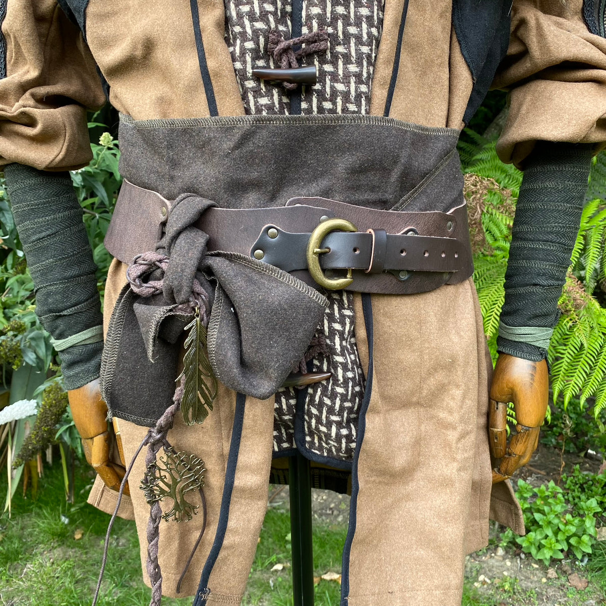 Medieval LARP belt and wraps with brown tunic; close-up of ornate details.