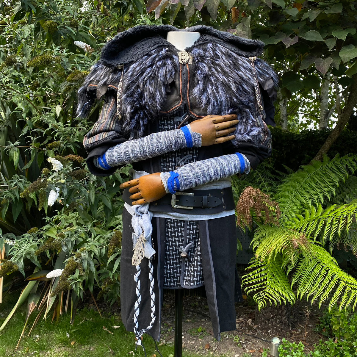 LARP medieval mannequin with blue herringbone wool wraps and fur cloak.