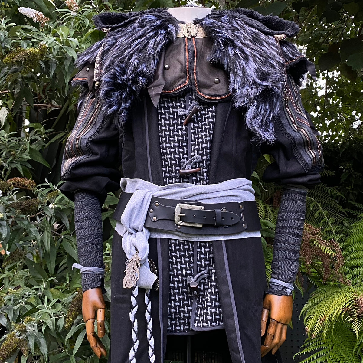 LARP medieval outfit with fur detail, grey wraps, and braided sash.