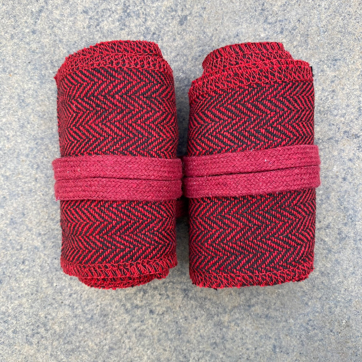 Rolled herringbone wool wraps, red-black, LARP medieval costume detail.