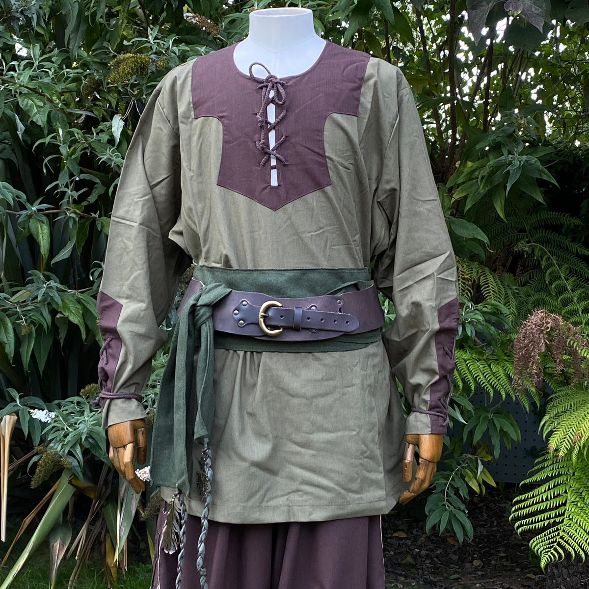 Green and brown LARP outfit with shirt, pants, and sash on mannequin.