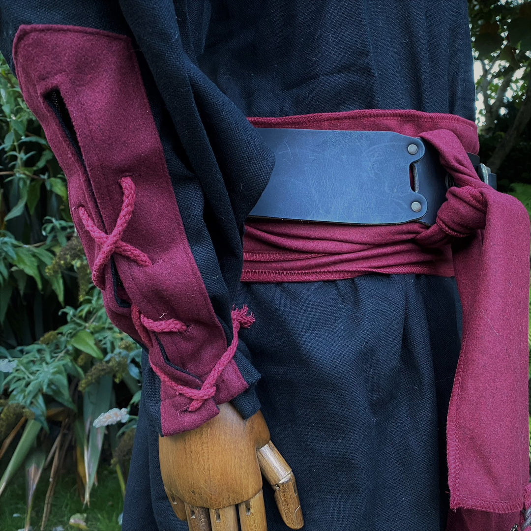 Black and burgundy medieval LARP costume with belt detail.
