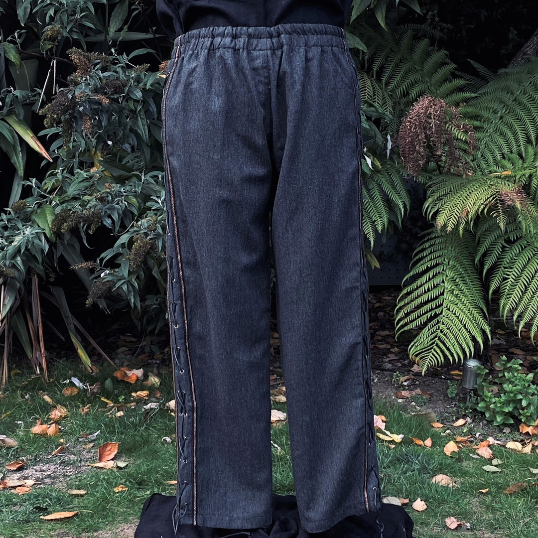 Front view of grey medieval pants with side lacing.