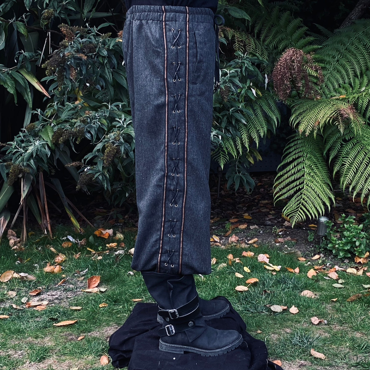 Grey wool straight leg pants with side lace detail.