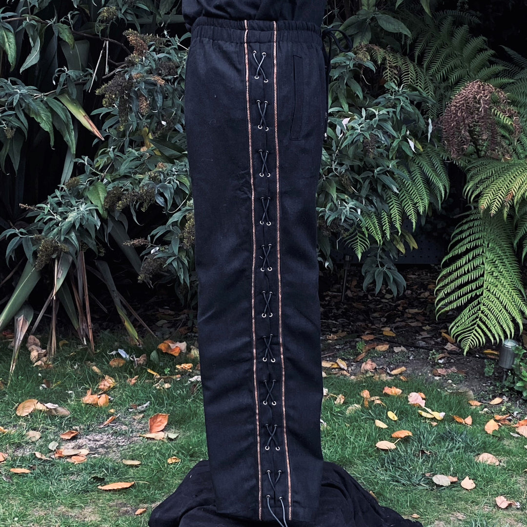Side view of LARP medieval pants, black wool with intricate side lacing.
