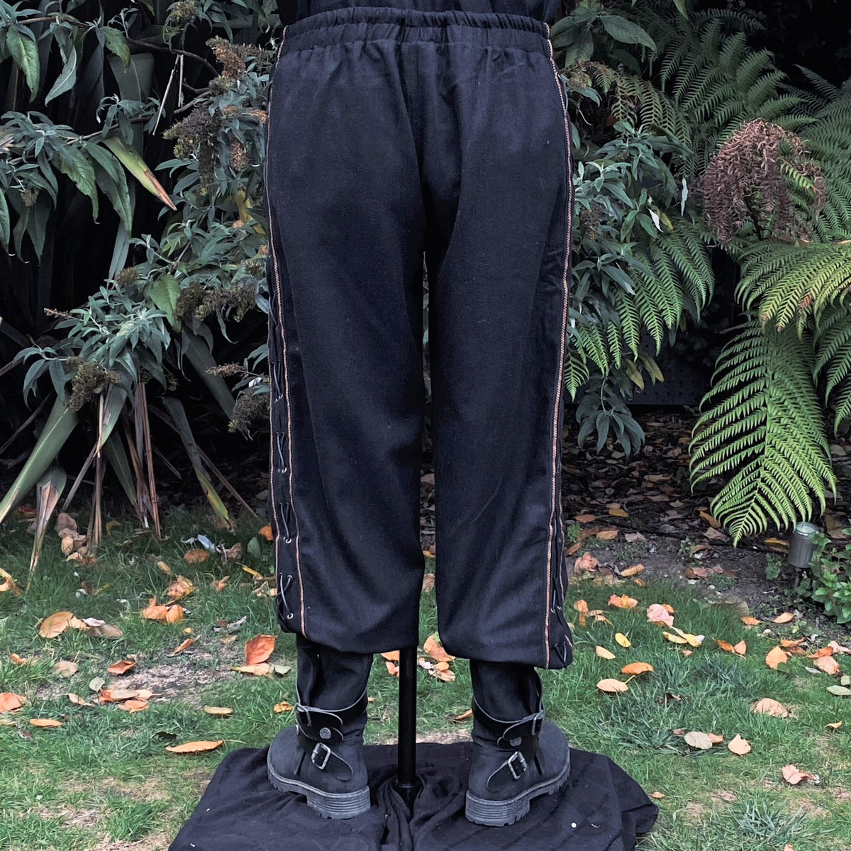 Rear view of LARP black pants with detailed side lace.