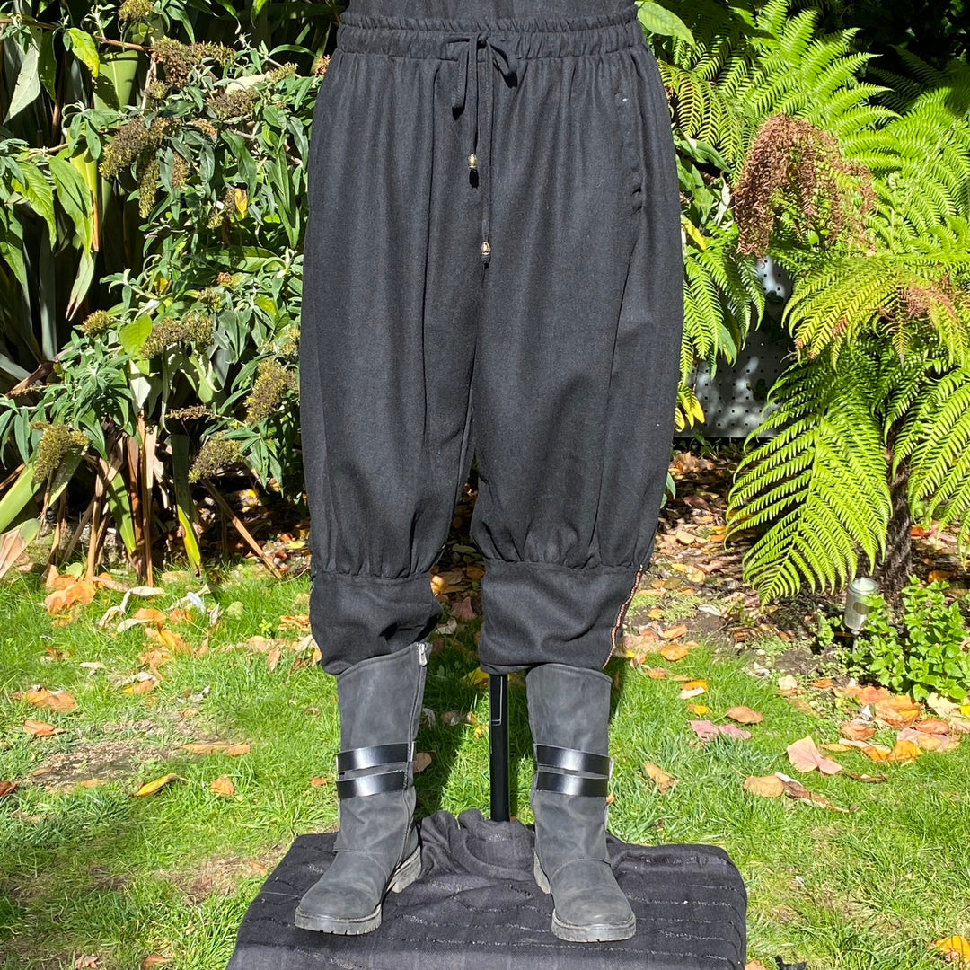 Black medieval-style LARP pants with elastic cuffs, front view.