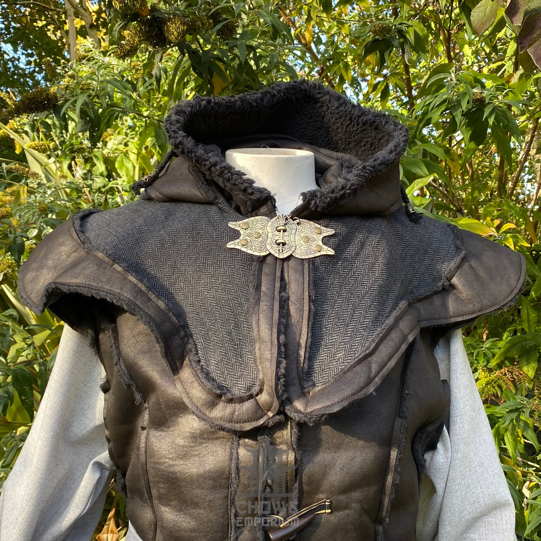Black medieval LARP waistcoat with fur-lined hood and ornate metal clasp.