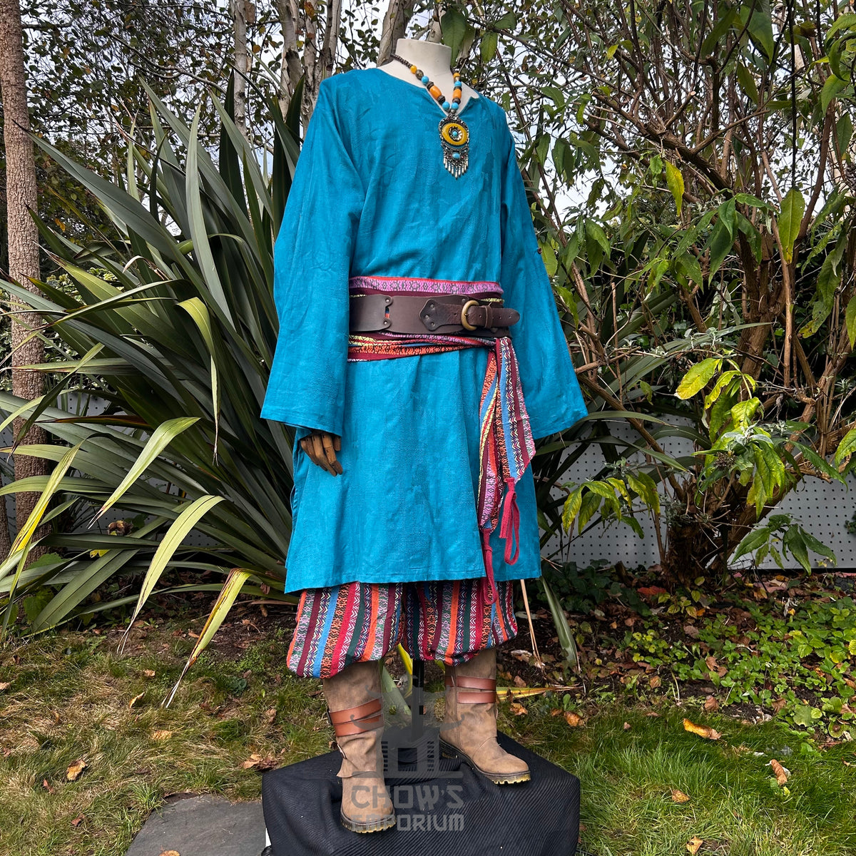 Turquoise medieval tunic and striped trousers with a brown belt for LARP.